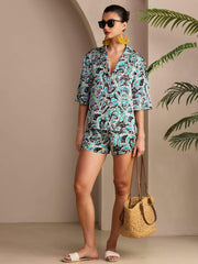 Women's mulberry silk botanical print short sleeve button-up pajamas set with matching shorts.