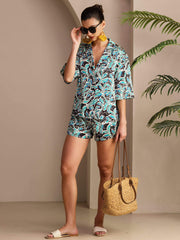 Women's mulberry silk botanical print short sleeve button-up pajama set in blue, black, and white.