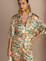 Women's 19Momme mulberry silk pajama set with colorful crocodile and palm tree print, short sleeves, and button-up top.