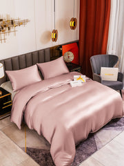 Pink 19 Momme mulberry silk duvet cover set with two pillowcases on a bed.