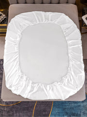 White 19 Momme mulberry silk fitted sheet, smooth and luxurious, on a bed.