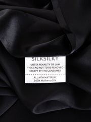Black 100% Mulberry Silk fabric with a white care tag showing "ALL NEW MATERIAL 100% Mulberry Silk".