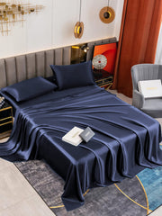 Dark blue 19 Momme mulberry silk bedding set with fitted sheet, flat sheet, and two pillowcases.