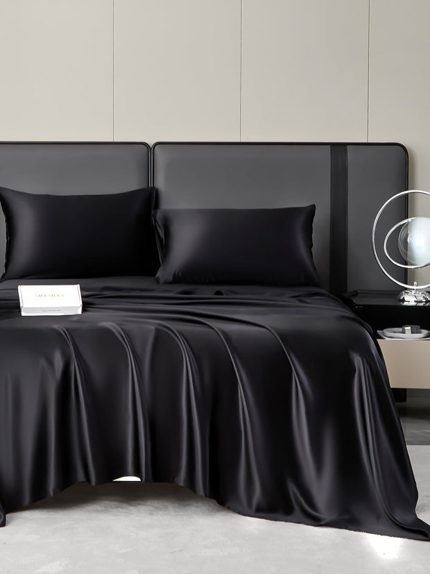 Black 19 Momme mulberry silk bedding set with fitted sheet, flat sheet, and two pillowcases.