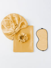 Golden mulberry silk beauty sleep set: bonnet, envelope pillowcase, scrunchie, and eye mask.