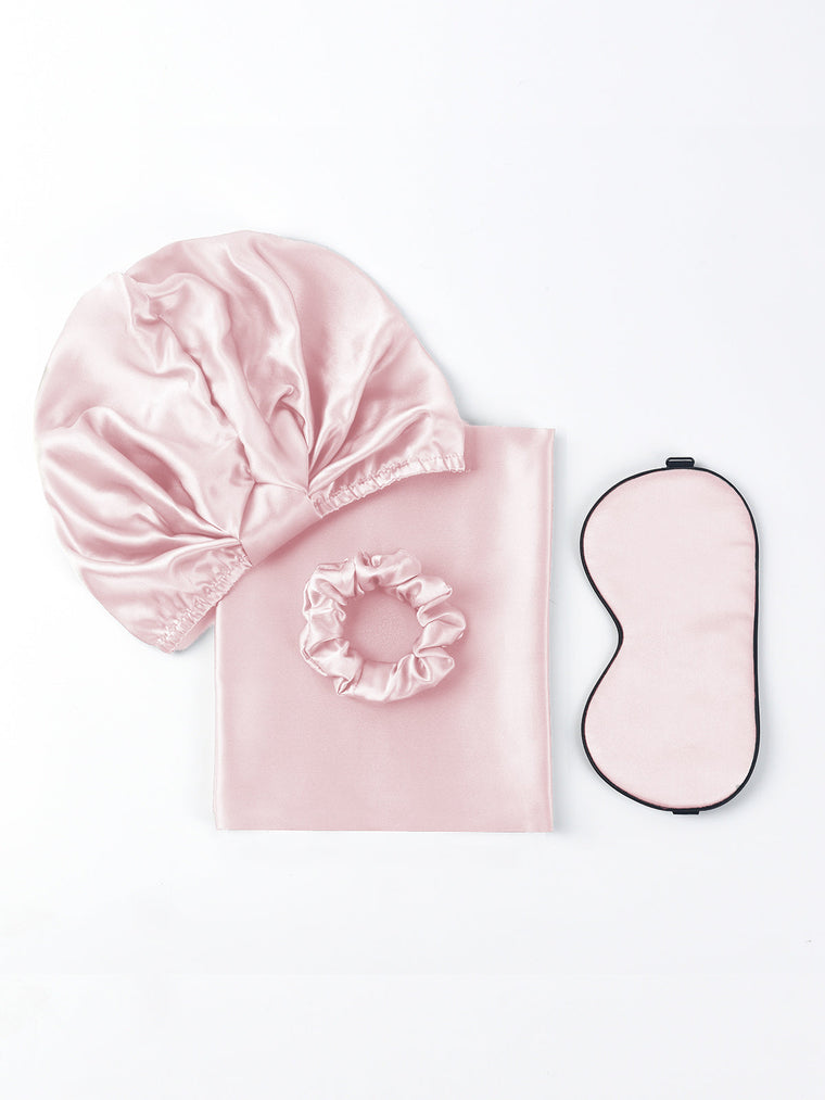 Pink 19Momme mulberry silk beauty sleep set with bonnet, scrunchie, pillowcase, and eye mask.