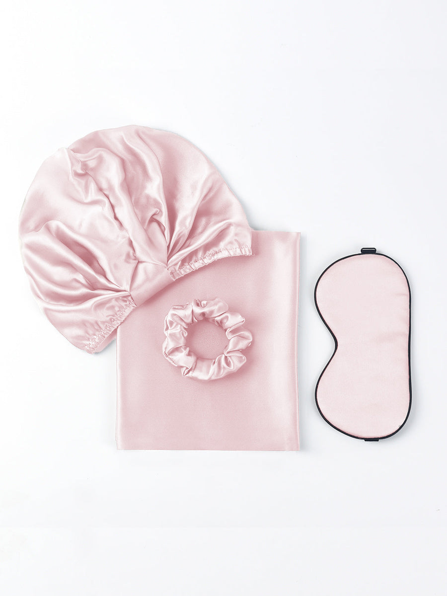 Pink 19Momme mulberry silk beauty sleep set with bonnet, scrunchie, pillowcase, and eye mask.