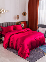 Luxurious mulberry silk 4-piece bedding set in vibrant fuchsia, including duvet cover, fitted sheet, and two pillowcases.