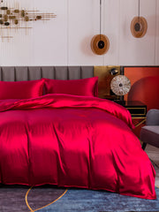 Luxurious 19 Momme mulberry silk duvet cover set in vibrant red, including fitted sheet and two pillowcases.