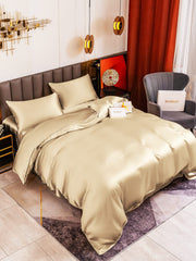 Beige 19 Momme mulberry silk duvet cover set with flat sheet and two pillowcases on a bed.