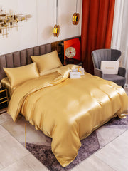 Luxurious gold 19Momme mulberry silk 4-piece bedding set with duvet cover, flat sheet, and two pillowcases.
