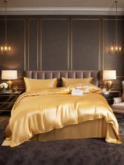 Champagne 19Momme mulberry silk 4-piece duvet cover set with flat sheet & pillowcases on a luxurious bed.