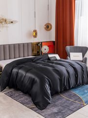 Black 19 Momme Mulberry silk seamless duvet cover on a bed, with a modern bedroom style.