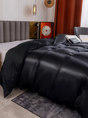 Black 19 Momme Mulberry Silk seamless duvet cover on a bed.