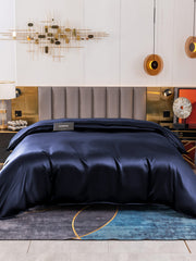 Navy blue 19 Momme Mulberry silk seamless duvet cover on a bed.