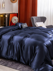 Navy blue 19 Momme Mulberry Silk seamless duvet cover on a bed.