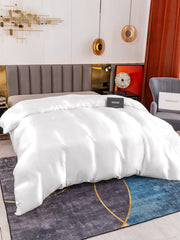 White 19 Momme Mulberry Silk Seamless Duvet Cover on a bed with a modern headboard.