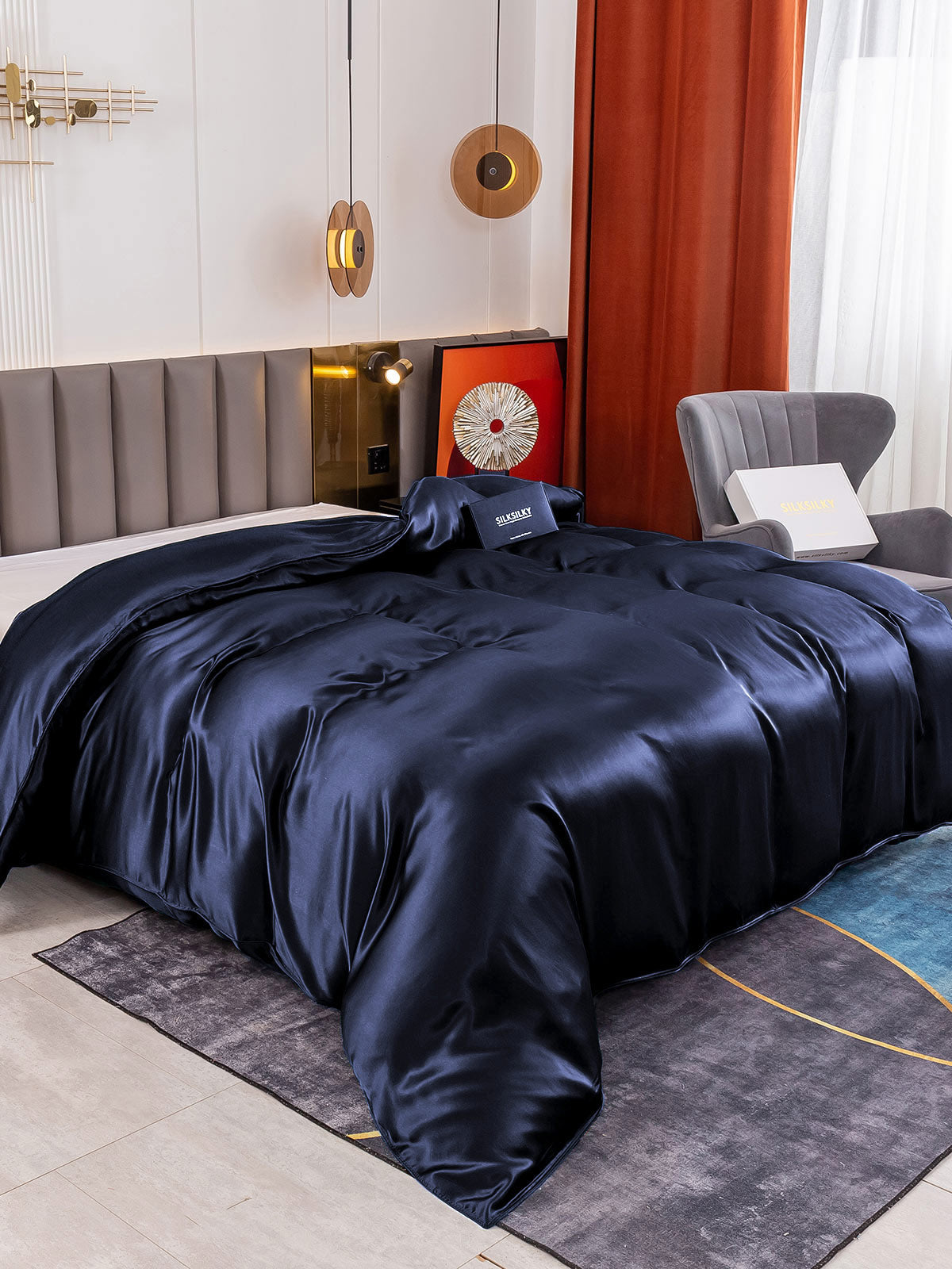 Dark blue 19 Momme Mulberry silk seamless duvet cover on a bed.