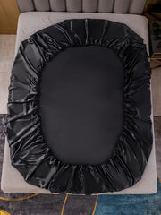 Black 19 Momme Mulberry silk seamless fitted sheet on a bed.