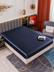 Dark blue 19Momme Mulberry silk seamless fitted sheet on a bed.