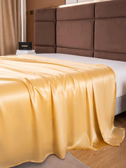 Golden 19 Momme Mulberry Silk Seamless Flat Sheet draped over a bed.
