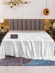 White 19Momme Mulberry Silk Seamless Flat Sheet draped on a bed with a black product box.