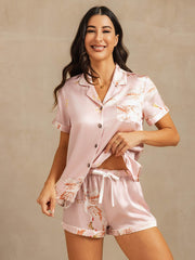 Women's pink 19 Momme mulberry silk short sleeve pajamas with crane print and notch collar.