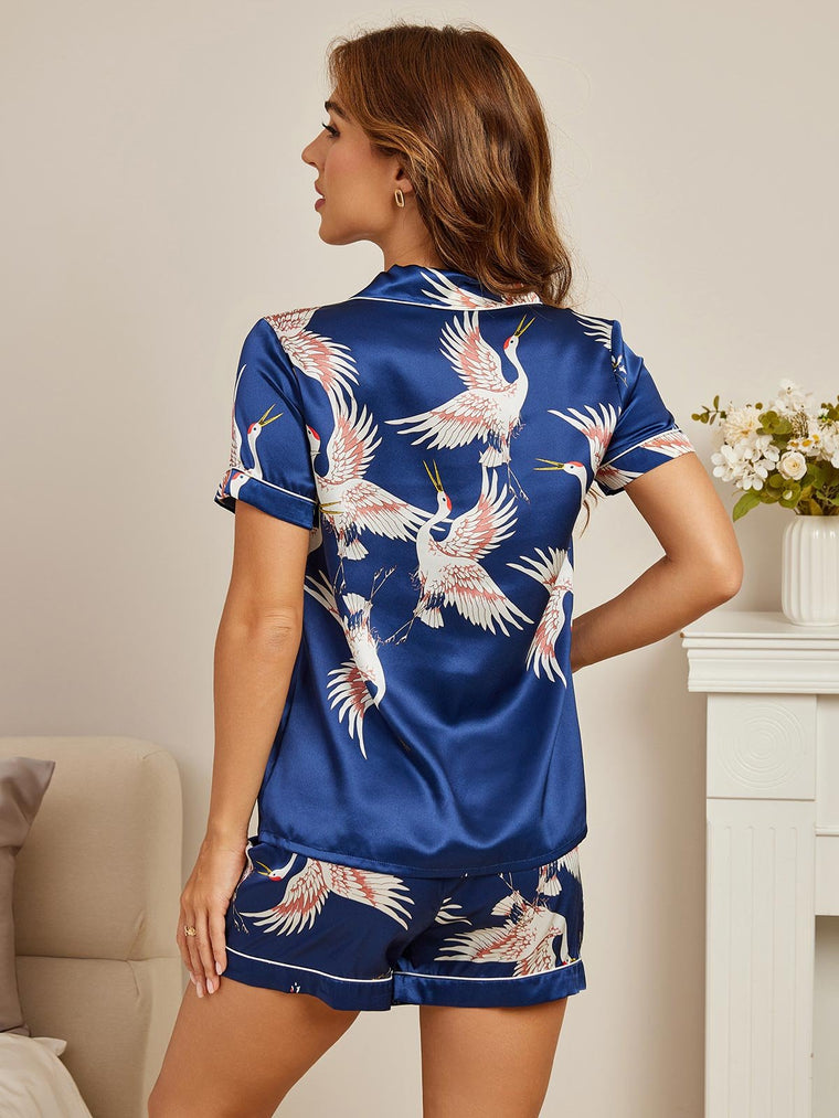 Women's navy blue mulberry silk short sleeve pajamas with crane print and white piping.