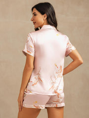 Women's pink 19 Momme mulberry silk short sleeve pajamas with crane print and notch collar.