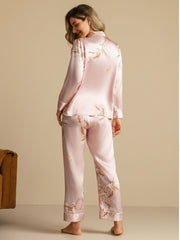 Women's pink 19 Momme mulberry silk pajamas with crane print, long sleeves, and notch collar.