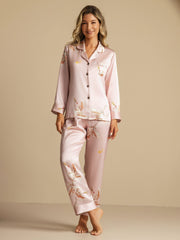 Women's pink 19Momme mulberry silk pajamas with crane print, long sleeves, and notch collar.