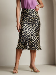 Women's 19 Momme mulberry silk leopard print stretch straight long skirt with a purple top.