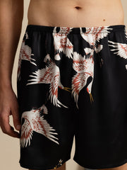 Men's black mulberry silk sleep shorts with white and red crane print, elastic waist.