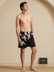Men's black mulberry silk sleep shorts with crane print and elastic waist.