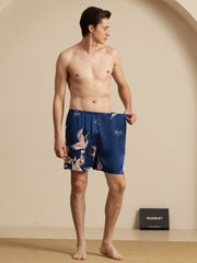 Men's navy blue mulberry silk sleep shorts with white and orange crane print, elastic waist.
