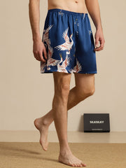 Men's dark blue 19Momme pure mulberry silk sleep shorts with crane print and elastic waist.