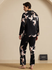 Men's black mulberry silk pajamas with white and pink crane print, long sleeves, and notch collar.