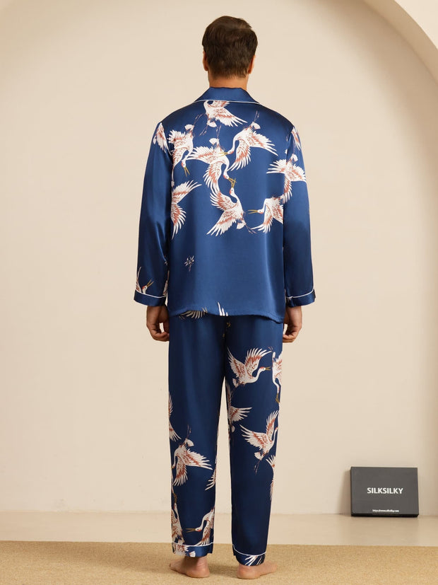 Men's mulberry silk pajamas in blue with a white crane print, long sleeve and notch collar style.