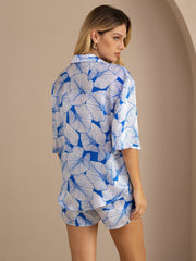 Women's 19 Momme pure mulberry silk pajama set with blue leaf print, short sleeves, and button-up top.