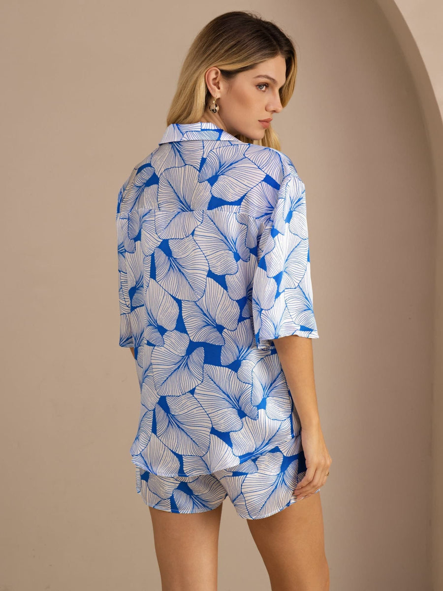 Women's 19 Momme pure mulberry silk pajama set with blue leaf print, short sleeves, and button-up top.