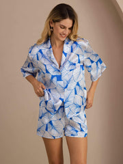Women's 19 Momme pure mulberry silk pajama set with blue leaf print, short sleeves, and button-up top.
