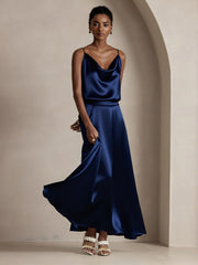 Woman in a navy blue mulberry silk A-line maxi skirt and matching camisole top.