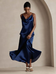 Woman in a flowing navy blue 19Momme mulberry silk A-line maxi skirt and matching camisole.