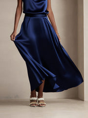 Navy 19Momme mulberry silk A-line maxi skirt with lining, worn by a woman with white braided sandals.