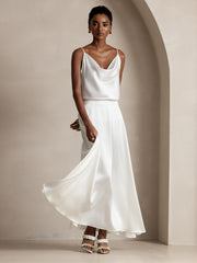 Woman in a white 19Momme mulberry silk A-line maxi skirt with lining and matching cowl neck silk top.