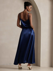 Woman in a navy blue mulberry silk A-line maxi skirt and matching camisole, viewed from behind.