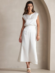 Woman in a white 19Momme mulberry silk A-line maxi skirt with zipper and matching silk top.