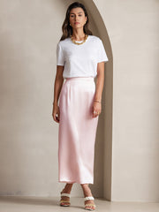 Women's light pink 19Momme mulberry silk A-line maxi skirt with a subtle sheen, paired with a white tee.