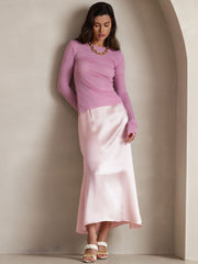 Woman wearing a light pink 19Momme mulberry silk A-line maxi skirt with a zipper design.