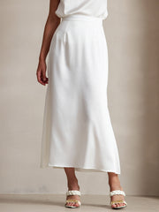 White 19Momme Mulberry silk A-line maxi skirt with zipper design, worn with white braided sandals.